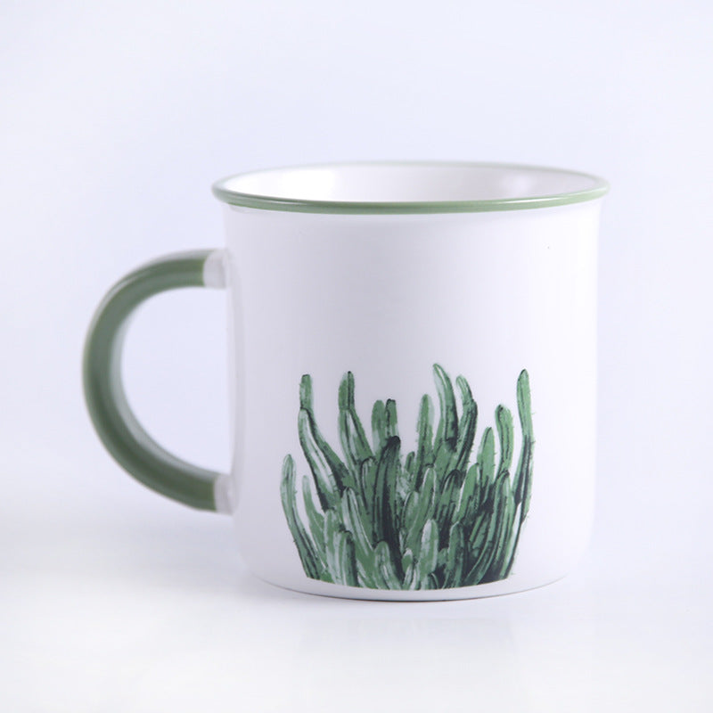 Tazza in ceramica con manico verde, foglie e piante verdi