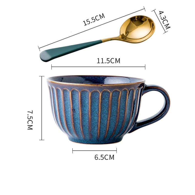 Tazza in ceramica con disegni in rilievo e cucchiaino dorato