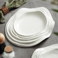 Piatto bianco in ceramica con bordi ad onde astratte ed irregolari