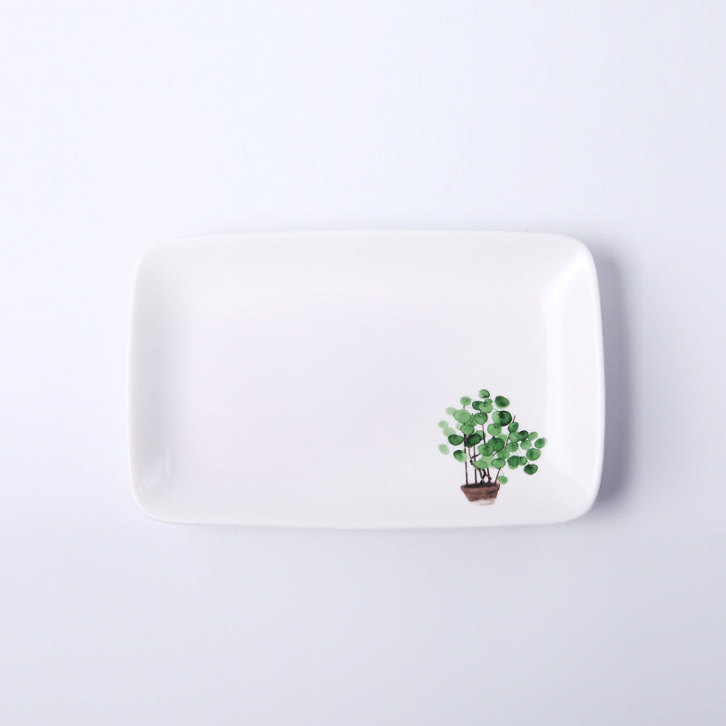 Piatti in ceramica con foglie e piante verdi
