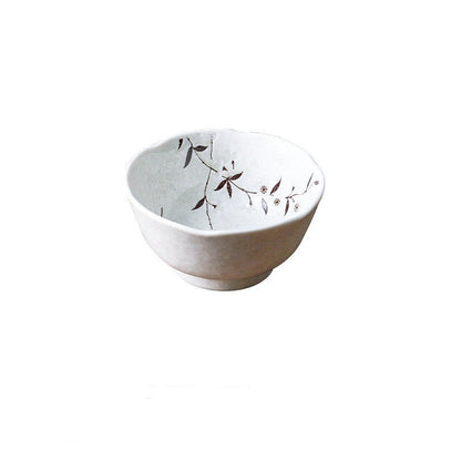 Piatti e ciotole in ceramica di colore bianco con disegni di rami fioriti