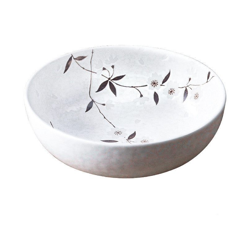 Piatti e ciotole in ceramica di colore bianco con disegni di rami fioriti
