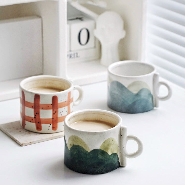 Tazze in ceramica con paesaggi e forme geometriche dipinte a mano