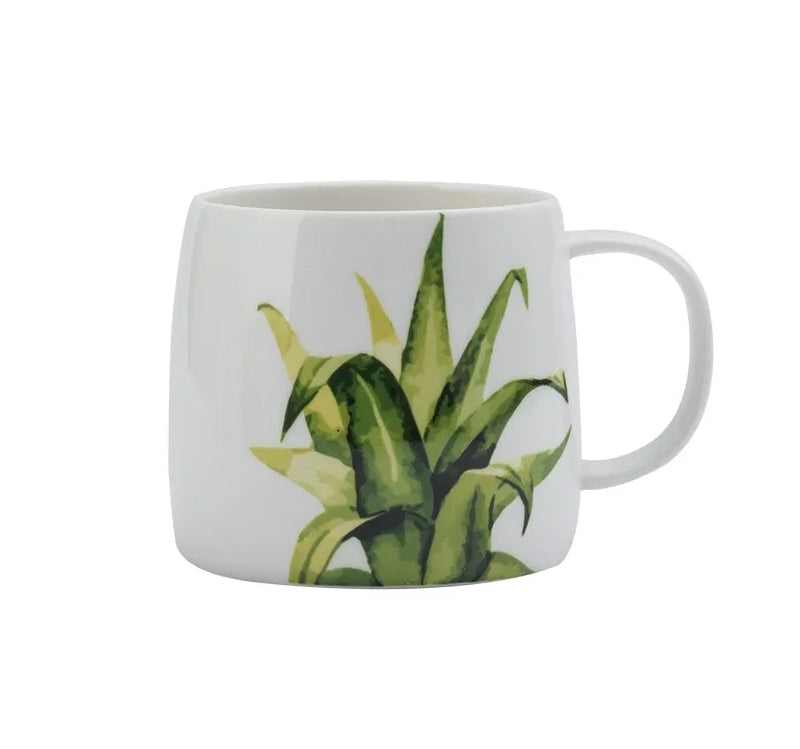 Tazza in ceramica con foglie e piante verdi
